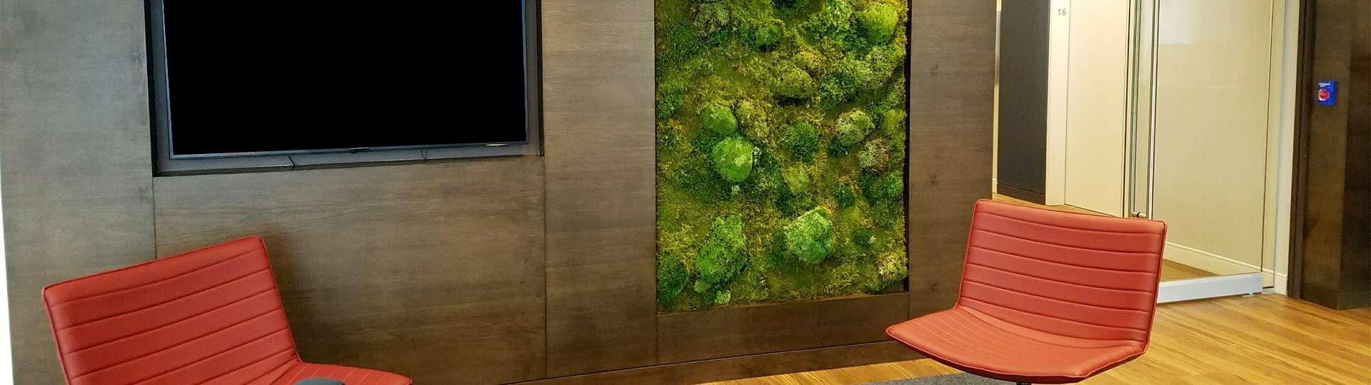 mcm chairs in lobby with a moss wall